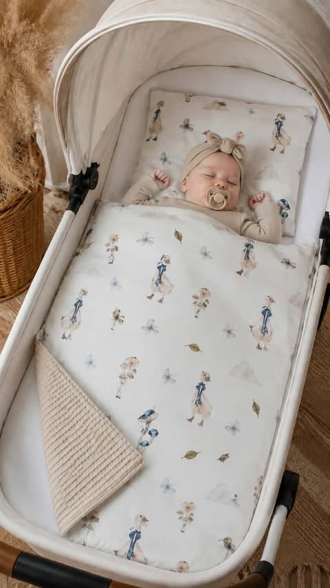 Sleeping newborn baby in white bassinet with patterned bedding and pacifier, next to woven basket on carpet